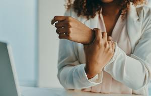 woman holding painful wrist
